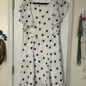 Adorable polkadot dress with flutter sleeves and button back